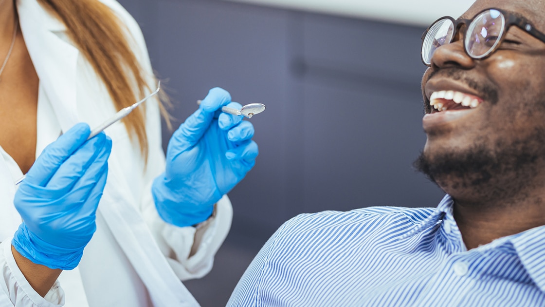 Smiling man talking to Dental Assistant